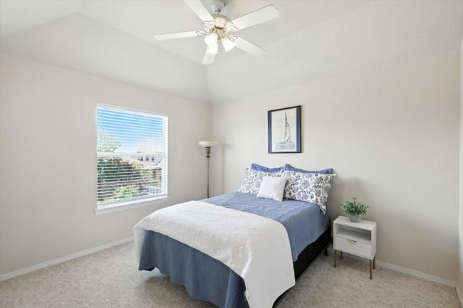 Bedroom with light colored carpet, lofted ceiling, and ceiling fan | Image 24
