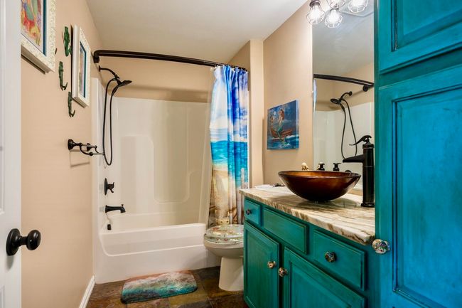 Bathroom with vanity, shower / bath combo with shower curtain, and toilet | Image 32