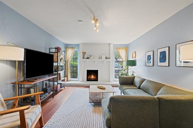 Living room featuring a large fireplace and wood finished floors | Image 9
