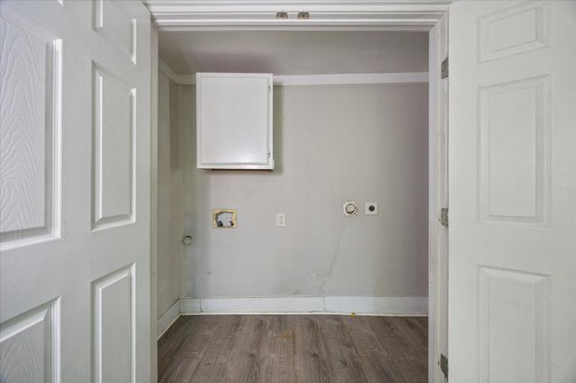 Laundry room featuring hookup for an electric dryer, dark wood finished floors, and hookup for a washing machine | Image 13