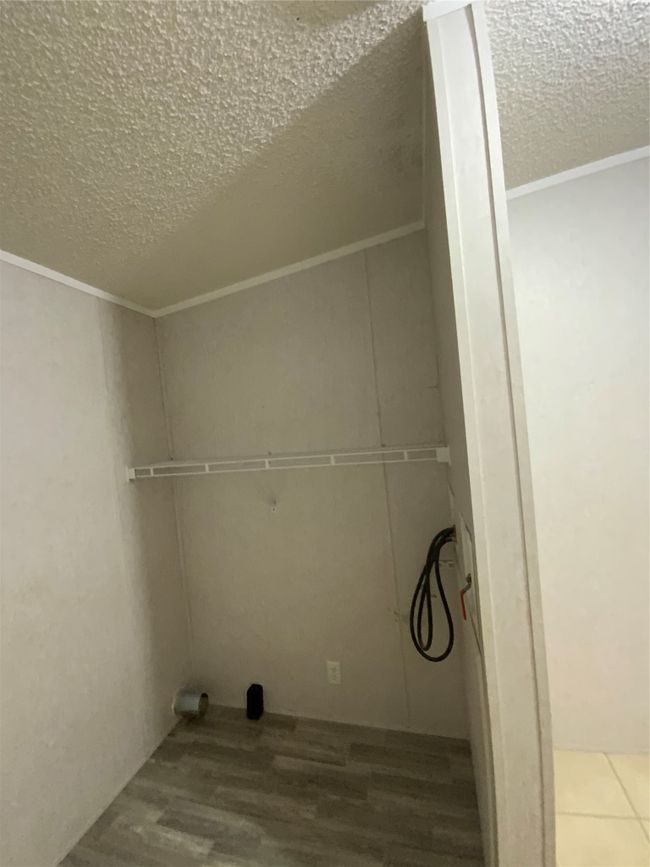 Clothes washing area with a textured ceiling, laundry area, ornamental molding, and hookup for a washing machine | Image 31