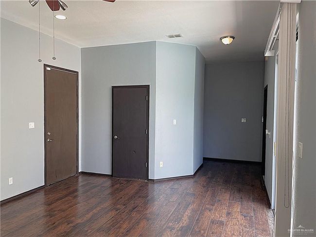 Spare room with dark wood-style floors, a ceiling fan, and recessed lighting | Image 19