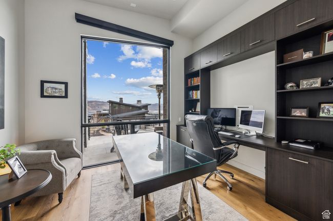 Office space featuring light wood-style floors | Image 30