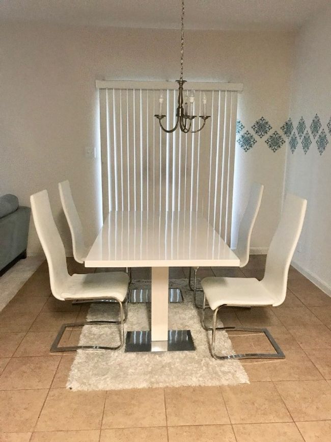 Dining space featuring tile patterned flooring and a chandelier | Image 5