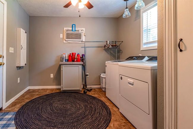 Laundry room is off the kitchen area. | Image 11