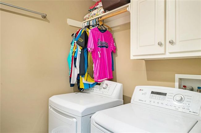 Washroom featuring washer and dryer and cabinet space | Image 22