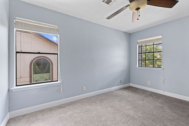 Bedroom #3 - Each one of the other bedrooms are bright with natural light and grounded in soft, neutral carpet, creating a calm backdrop for whatever life brings. | Image 28