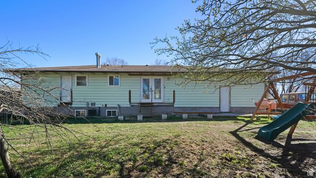 Back of property featuring a lawn, french doors, and a playground | Image 25