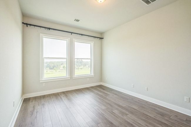 Empty room with wood finished floors and baseboards | Image 12