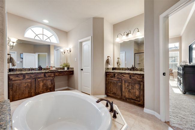 Full bathroom with a garden tub, a stall shower, two vanities, and tile patterned flooring | Image 17