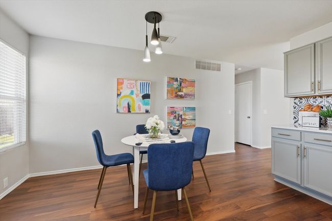 Dining area featuring dark wood finished floors and plenty of natural light | Image 12