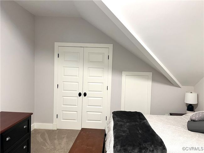 Bedroom 4 featuring lofted ceiling, carpet flooring, and a closet | Image 25