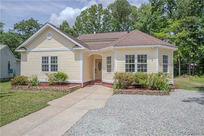 Bungalow-style house with a front lawn | Image 1