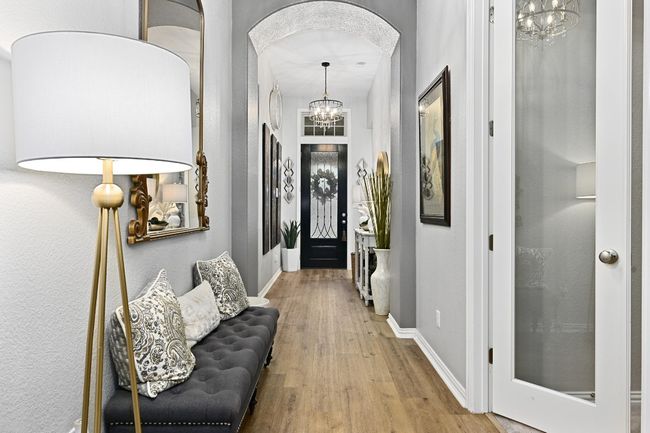Entrance foyer featuring a chandelier, and arched walkways | Image 5