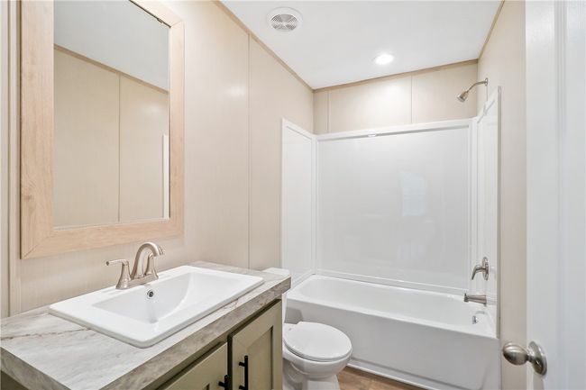 Bathroom featuring toilet, visible vents, tub / shower combination, and vanity | Image 13