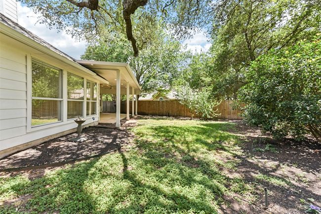 Fenced backyard with mature trees | Image 34