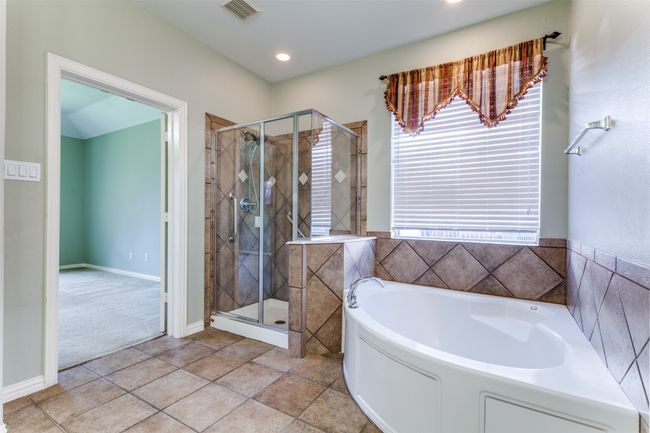 Full bathroom featuring a garden tub, a stall shower, tile patterned floors, and recessed lighting | Image 11