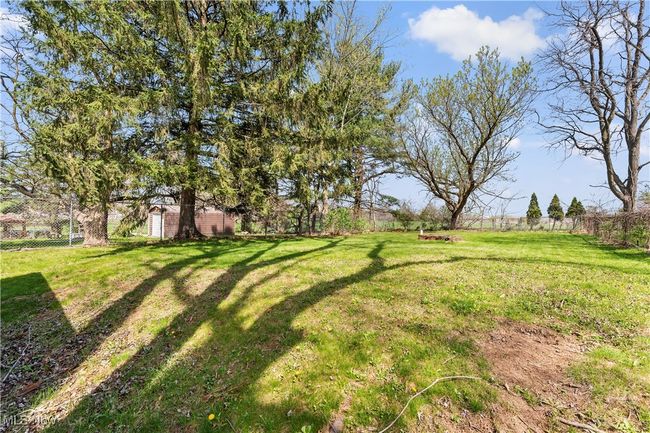 View of yard with a fenced backyard | Image 6