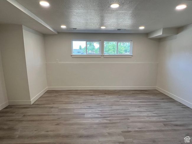 Below grade area featuring recessed lighting and wood finished floors | Image 12