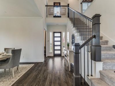 Foyer entrance with crown molding, a high ceiling, and dark hardwood / wood-style floors | Image 2