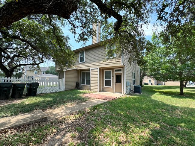 Rear view of house featuring a chimney, central AC unit, and a patio | Image 37