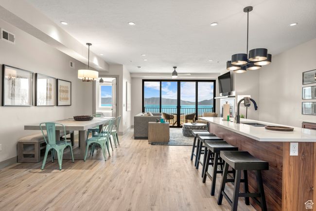 Dining area with a chandelier, light wood-style floors, baseboards, recessed lighting, and ceiling fan | Image 55