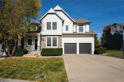 Front facade with a front lawn and a garage | Image 1