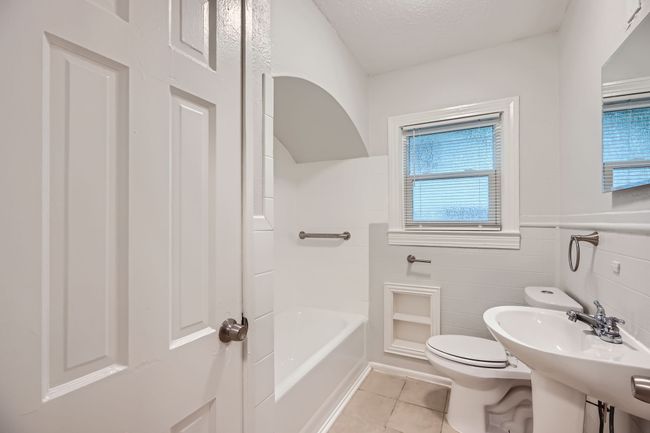 Full bathroom with a textured ceiling, toilet, and tile patterned flooring | Image 20