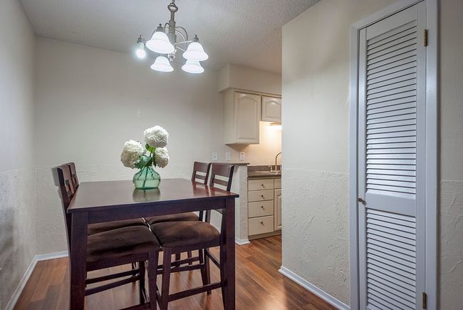 The dining area, illuminated by a chandelier, is perfect for intimate meals. | Image 10
