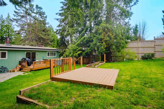 View of yard featuring a fenced backyard and a deck | Image 32
