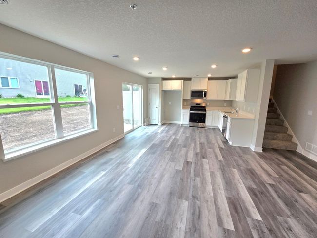 Beautiful living space with lots of windows bring in lots of natural light. Photo is of actual home. Colors and options may vary. Ask Sales Agent for details. | Image 19