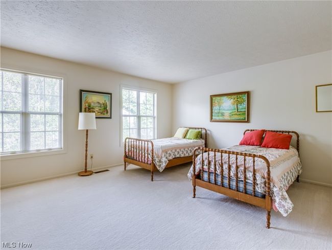 Bedroom with light carpet and a textured ceiling | Image 25