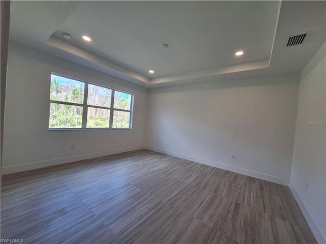Primary bedroom suite with tray ceiling and private, preserve view | Image 12
