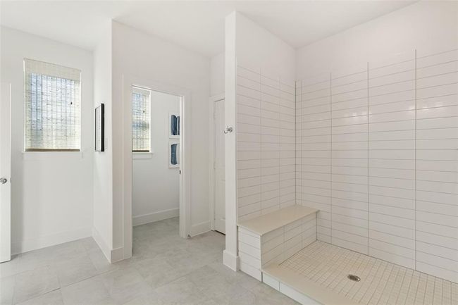 Bathroom featuring tiled shower and tile floors | Image 19