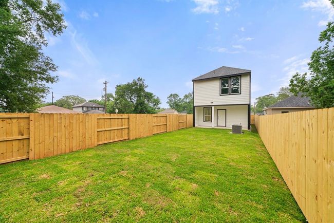 Another view of this spacious and private backyard retreat. Enjoy the serenity of this expansive, fully-fenced yard, perfect for relaxation, outdoor play, or entertaining guests. With lush grass and privacy on all sides, it’s your personal oasis. | Image 28