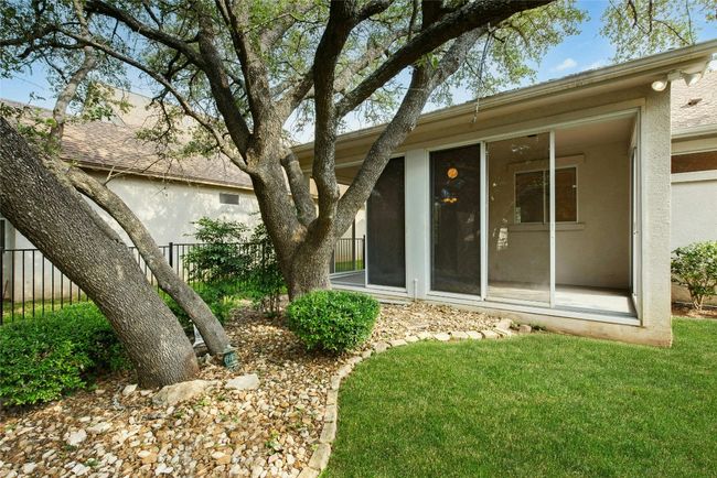 Back of property featuring stucco siding and a sunroom | Image 24
