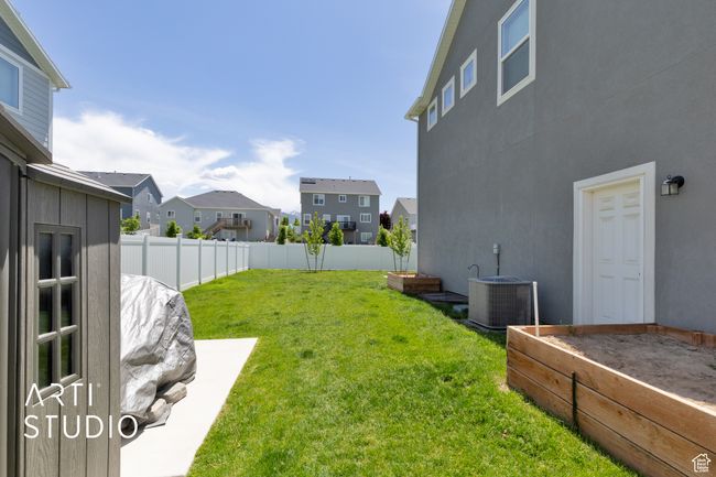 View of yard with cooling unit, a residential view, and a garden | Image 33