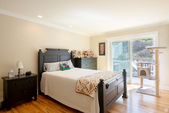 Bedroom with recessed lighting, light wood finished floors, access to exterior, and crown molding | Image 10