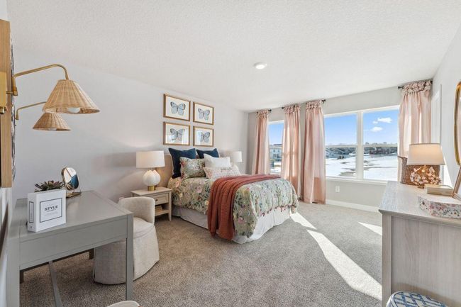 The first of two very large secondary bedrooms upstairs. Look at that wall of windows! There's even a window in the walk in closet. Photo of model home, colors and finishes will vary. | Image 30