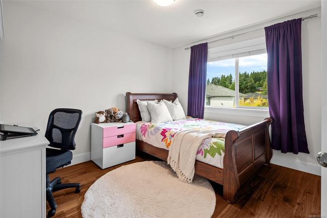 Bedroom featuring wood finished floors and baseboards | Image 34
