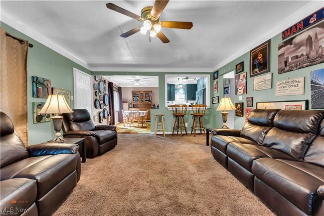 Living area featuring carpet floors and a ceiling fan | Image 7