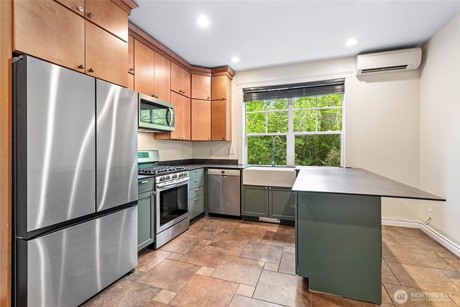 Beautiful second full kitchen with custom cabinets and ductless heating and cooling. | Image 26