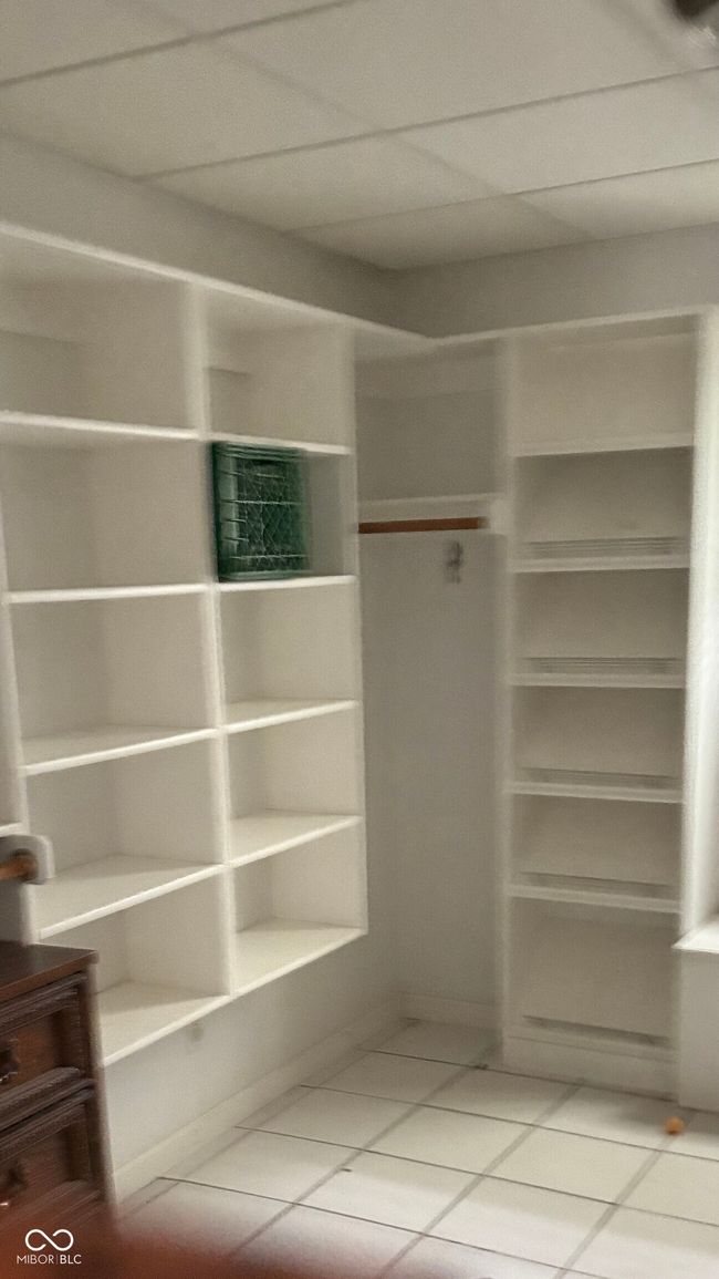 spacious closet featuring light tile patterned flooring | Image 8