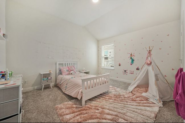 Bedroom featuring carpet floors, baseboards, and lofted ceiling | Image 15