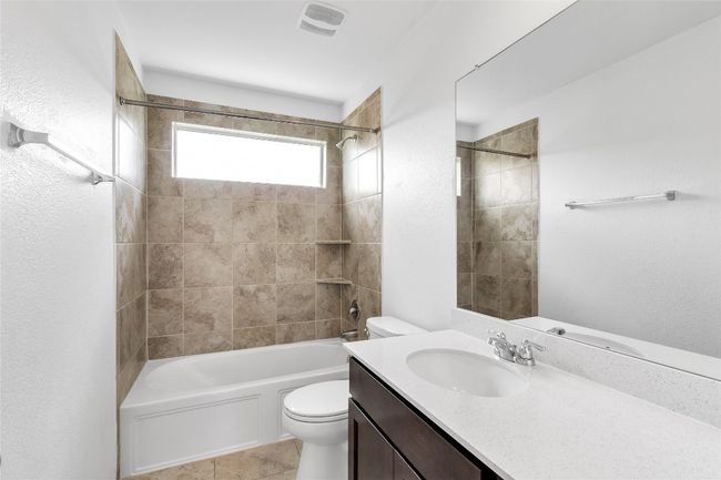 Bathroom with vanity, shower / tub combination, and tile patterned flooring | Image 30