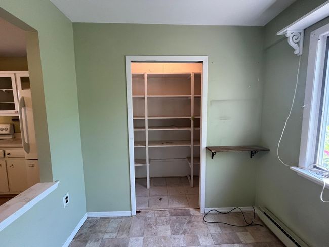 Walk in closet with a baseboard radiator | Image 5