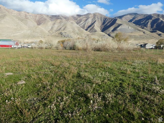 View of mountain backdrop featuring rural landscape | Image 13