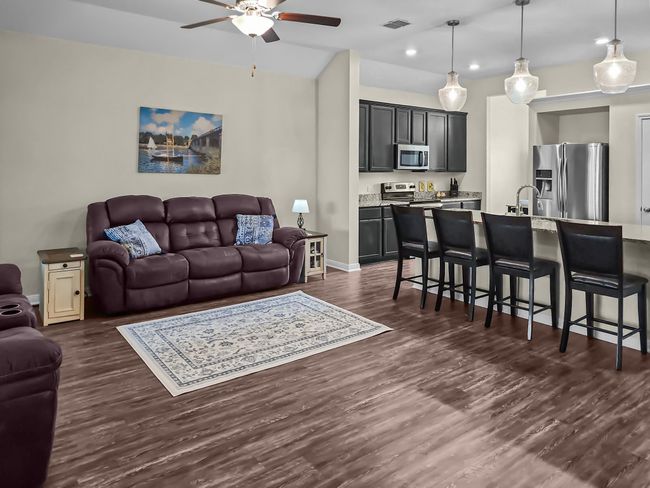 Living area with ceiling fan, recessed lighting, and dark wood-style floors | Image 10
