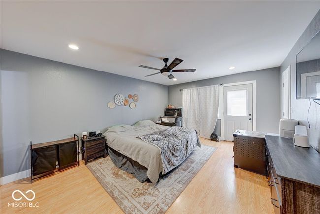 spacious master bedroom with a doorway that leads to a deck and enclosed sitting area | Image 33