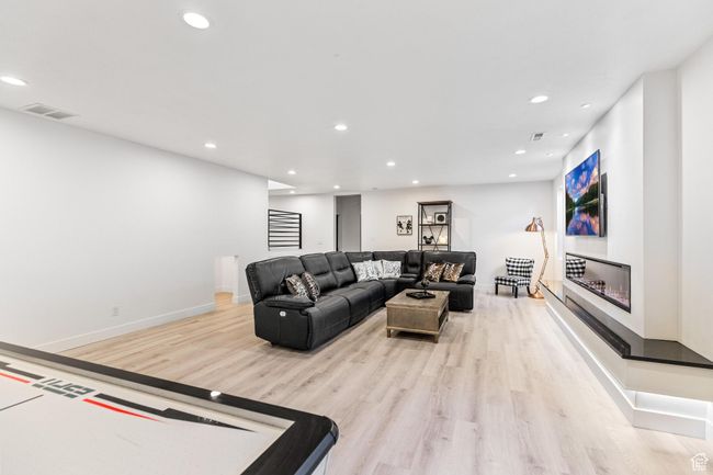 Living room featuring light wood-style floors, baseboards, visible vents, and recessed lighting | Image 37